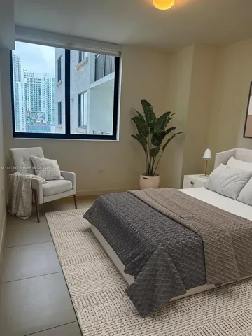 a bedroom with a bed and window