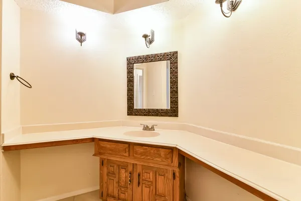 a bathroom with a sink a vanity and a mirror