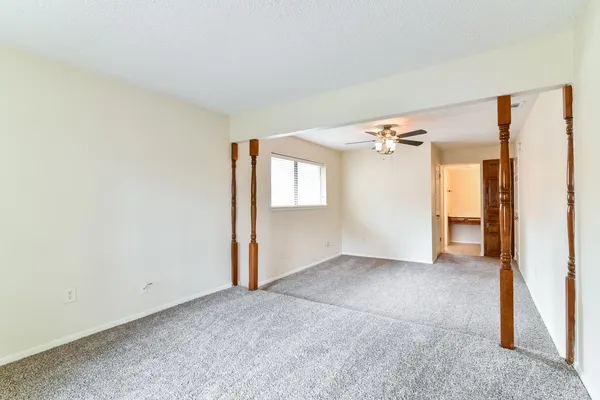 a view of a big room with closet and windows