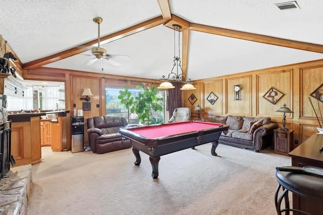 a kitchen with sink a window and cabinets