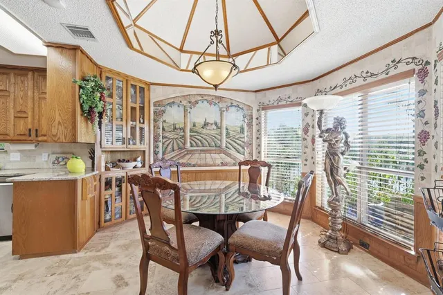 a living room with furniture a chandelier and a chair