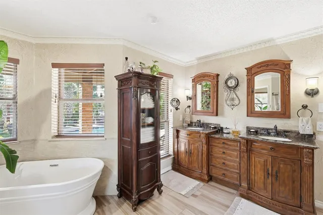 a bathroom with double vanity sinks and a shower