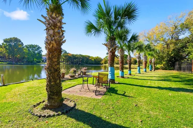 a view of swimming pool with outdoor seating and plants