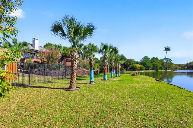 a view of yard from deck with patio