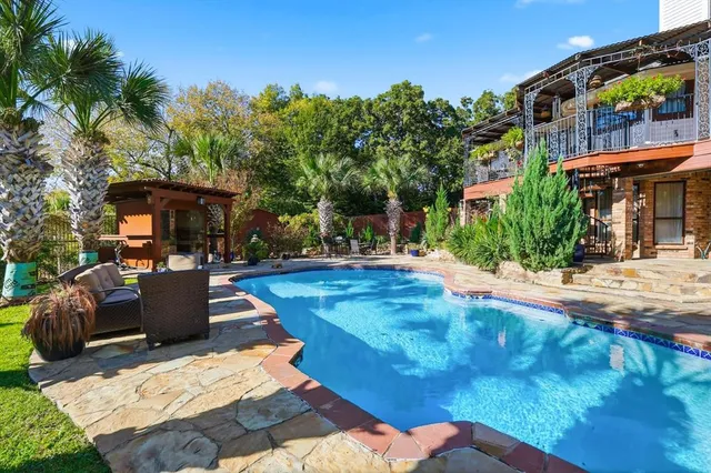 an aerial view of residential houses with outdoor space and lake view