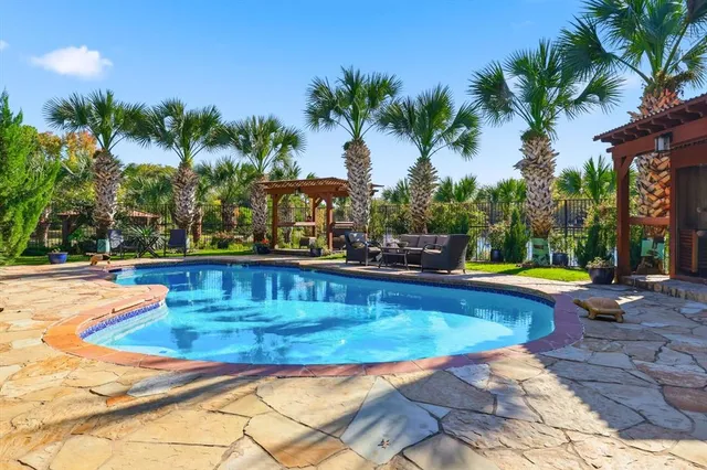 a view of a building with garden and sitting area