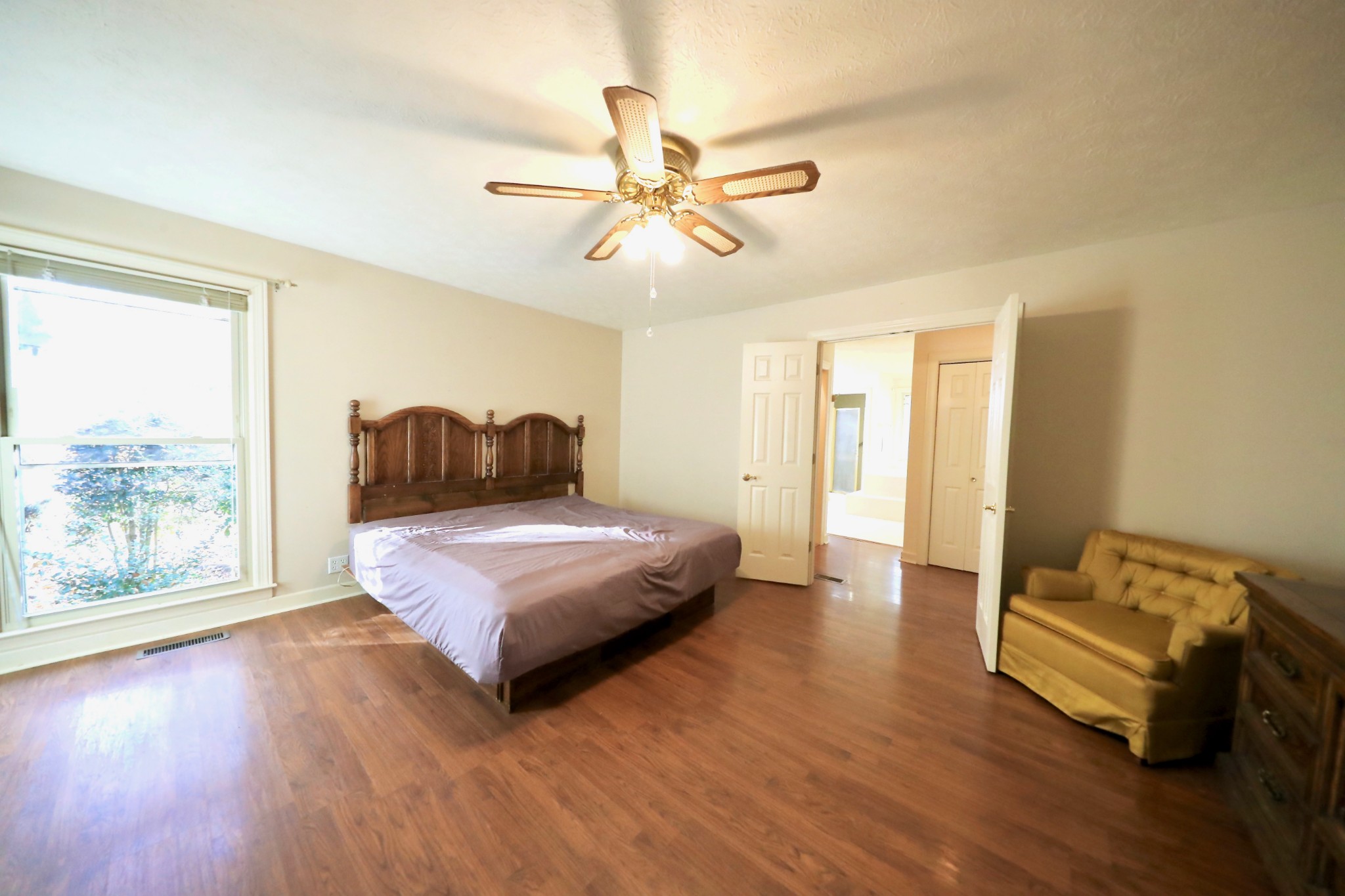 6982 New Chapel Road Springfield, TN 37172 - Photo 12 of 32 a bedroom with a bed and wooden floor