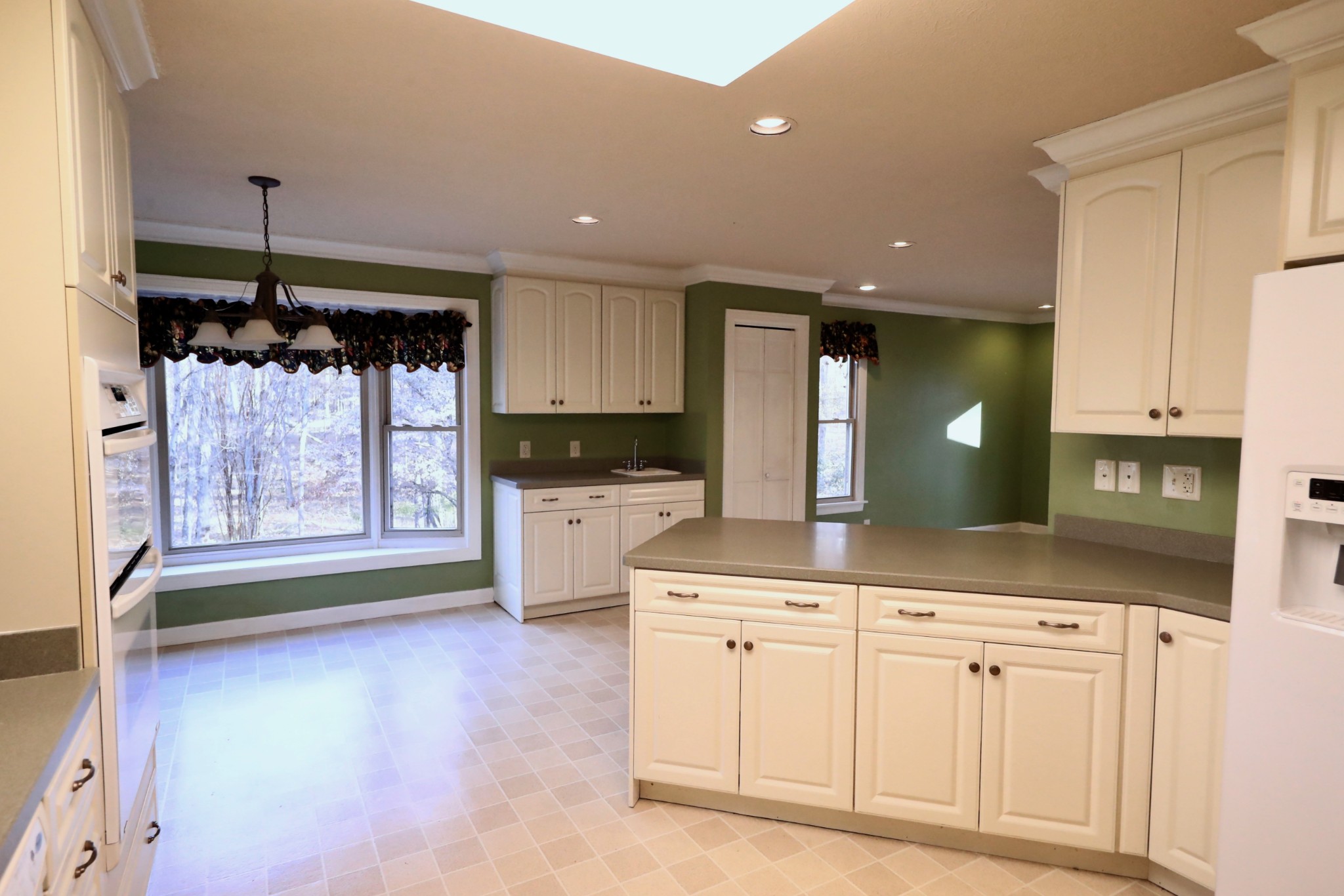 6982 New Chapel Road Springfield, TN 37172 - Photo 8 of 32 a kitchen with white cabinets and chandelier