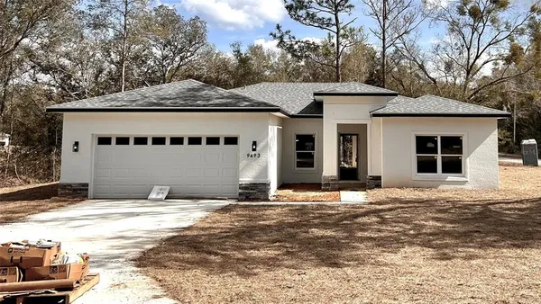 a view of a house with a yard and garage
