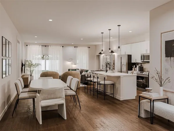 a large kitchen with a table and chairs