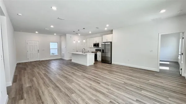 a view of a kitchen with a sink and a refrigerator