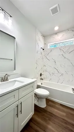 a bathroom with a sink toilet a mirror and shower