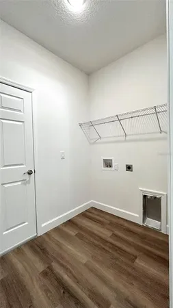 a view of a room with wooden floor