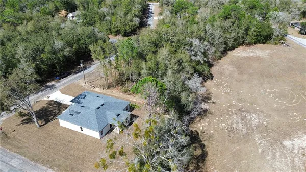 an aerial view of house with yard