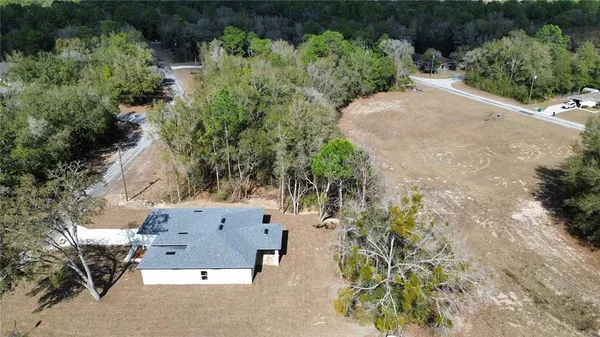 an aerial view of a house with a yard