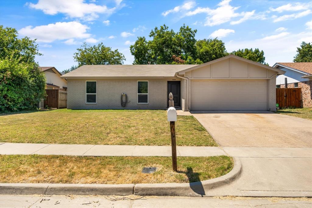 a front view of house with yard and trees
