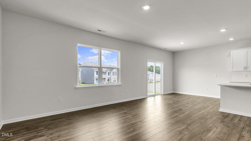1281 Pavo Path Wendell, NC 27591 - Photo 14 of 54 an empty room with wooden floor and windows