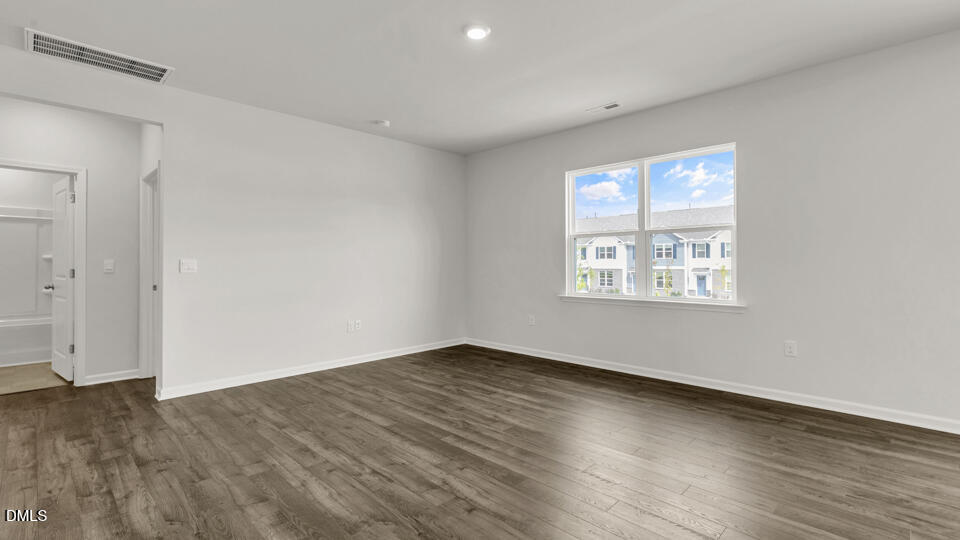 1281 Pavo Path Wendell, NC 27591 - Photo 16 of 54 an empty room with wooden floor and windows