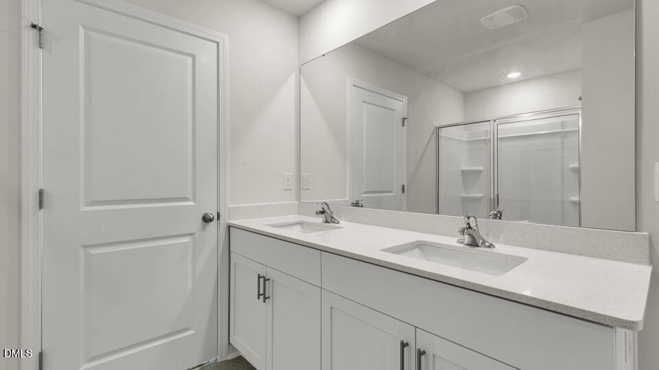 1281 Pavo Path Wendell, NC 27591 - Photo 24 of 54 a bathroom with 2 sink and a mirror