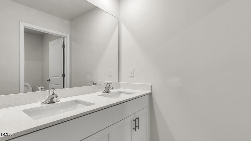 1281 Pavo Path Wendell, NC 27591 - Photo 35 of 54 a bathroom with a sink and a mirror