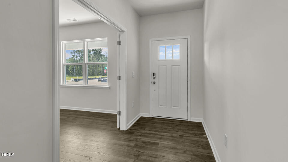 1281 Pavo Path Wendell, NC 27591 - Photo 5 of 54 an empty room with wooden floor closet and windows