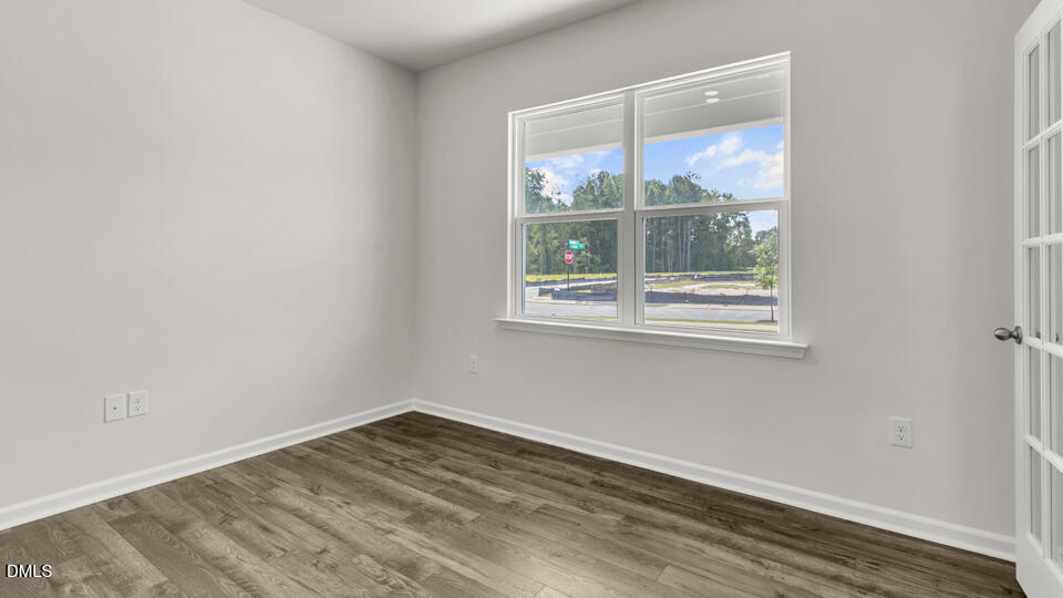 1281 Pavo Path Wendell, NC 27591 - Photo 6 of 54 an empty room with wooden floor and windows