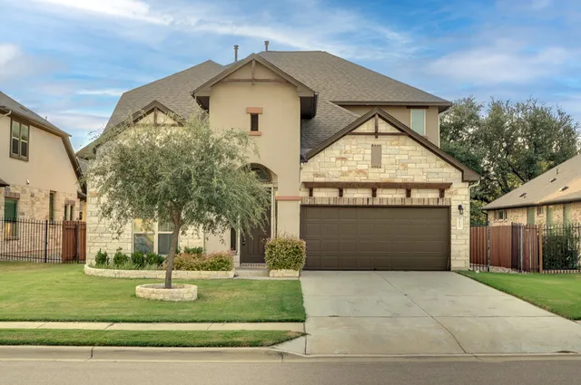 a front view of a house with a yard and garage