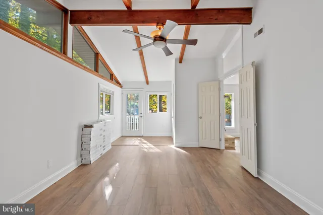 a view of hallway with wooden floor and stairs