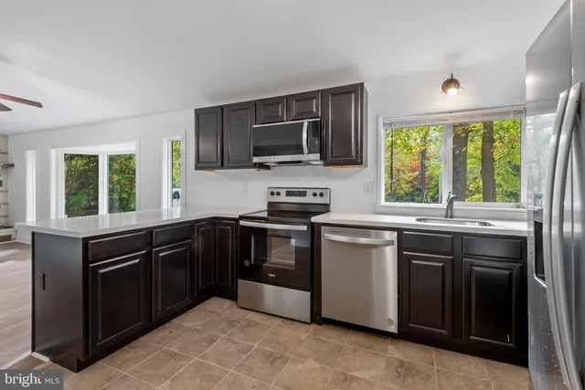 a kitchen with a sink stove and microwave