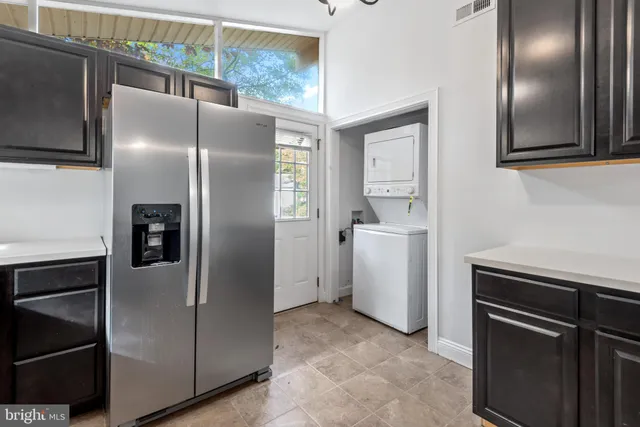 a kitchen with a refrigerator and a sink