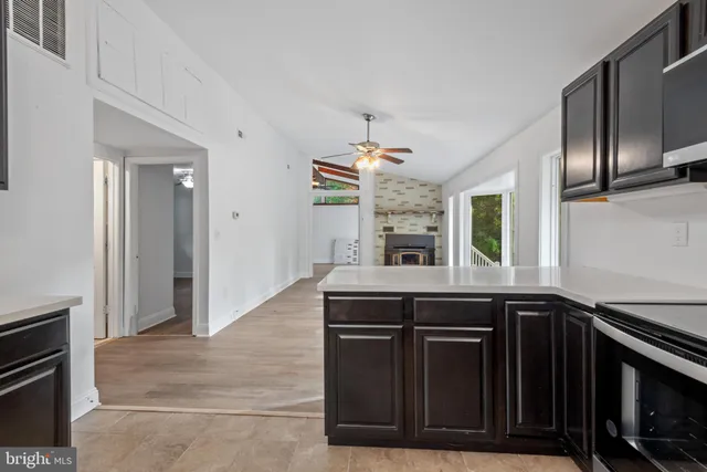 a kitchen with granite countertop a stove and a sink