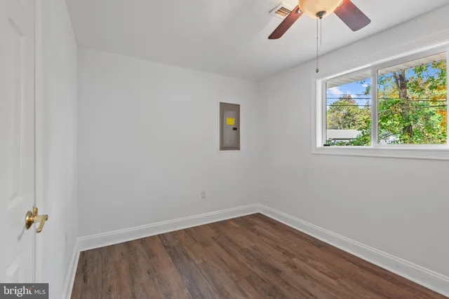 wooden floor in an empty room with a window