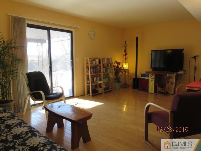 7505 Hana Road Edison, NJ 08817 - Photo 14 of 15 a living room with furniture and a flat screen tv
