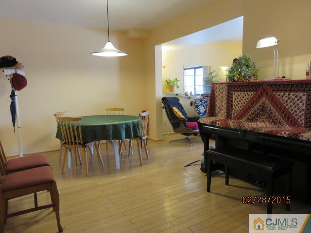7505 Hana Road Edison, NJ 08817 - Photo 3 of 15 a living room with furniture a piano and a potted plant