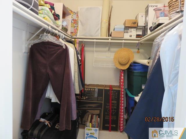 7505 Hana Road Edison, NJ 08817 - Photo 8 of 15 a view of walk in closet with clothes and shoes