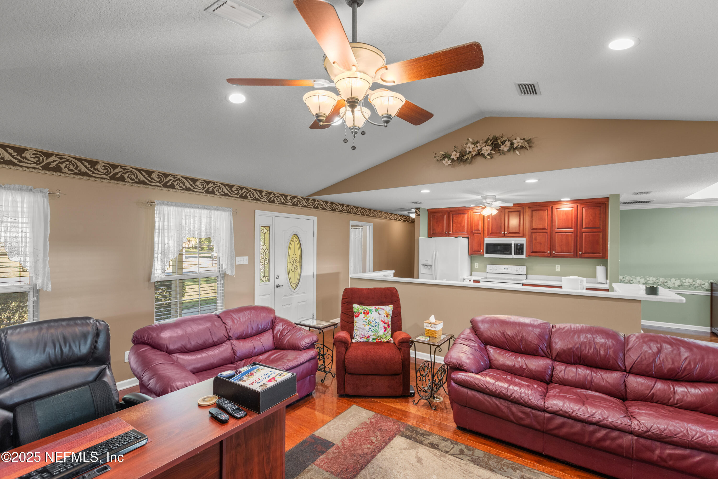 618 Southeast 44th Street Keystone Heights, FL 32656 - Photo 30 of 66 a living room with furniture ceiling fan and a rug