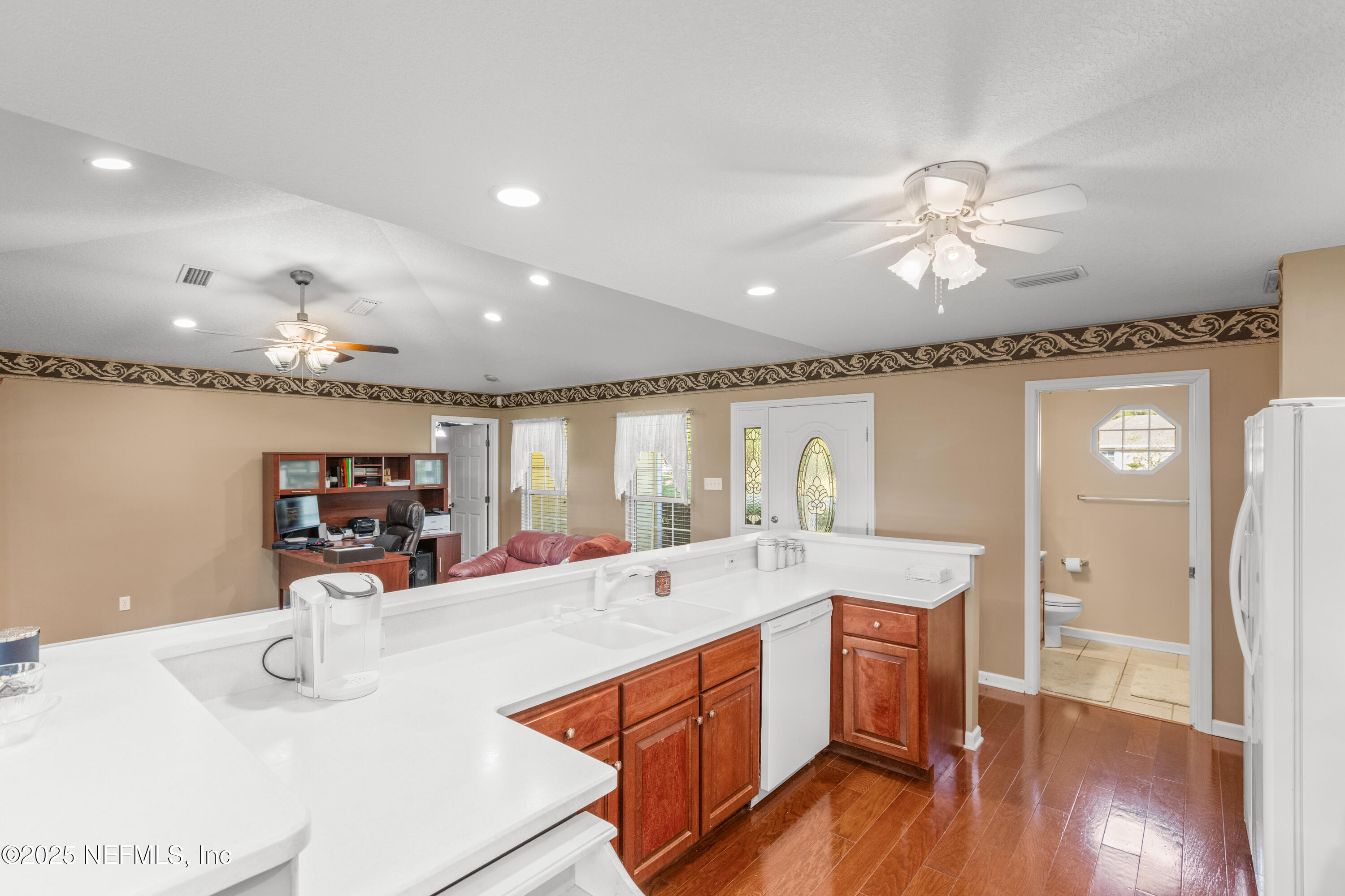 618 Southeast 44th Street Keystone Heights, FL 32656 - Photo 34 of 66 a large kitchen with stainless steel appliances a large counter top a stove and a chandelier