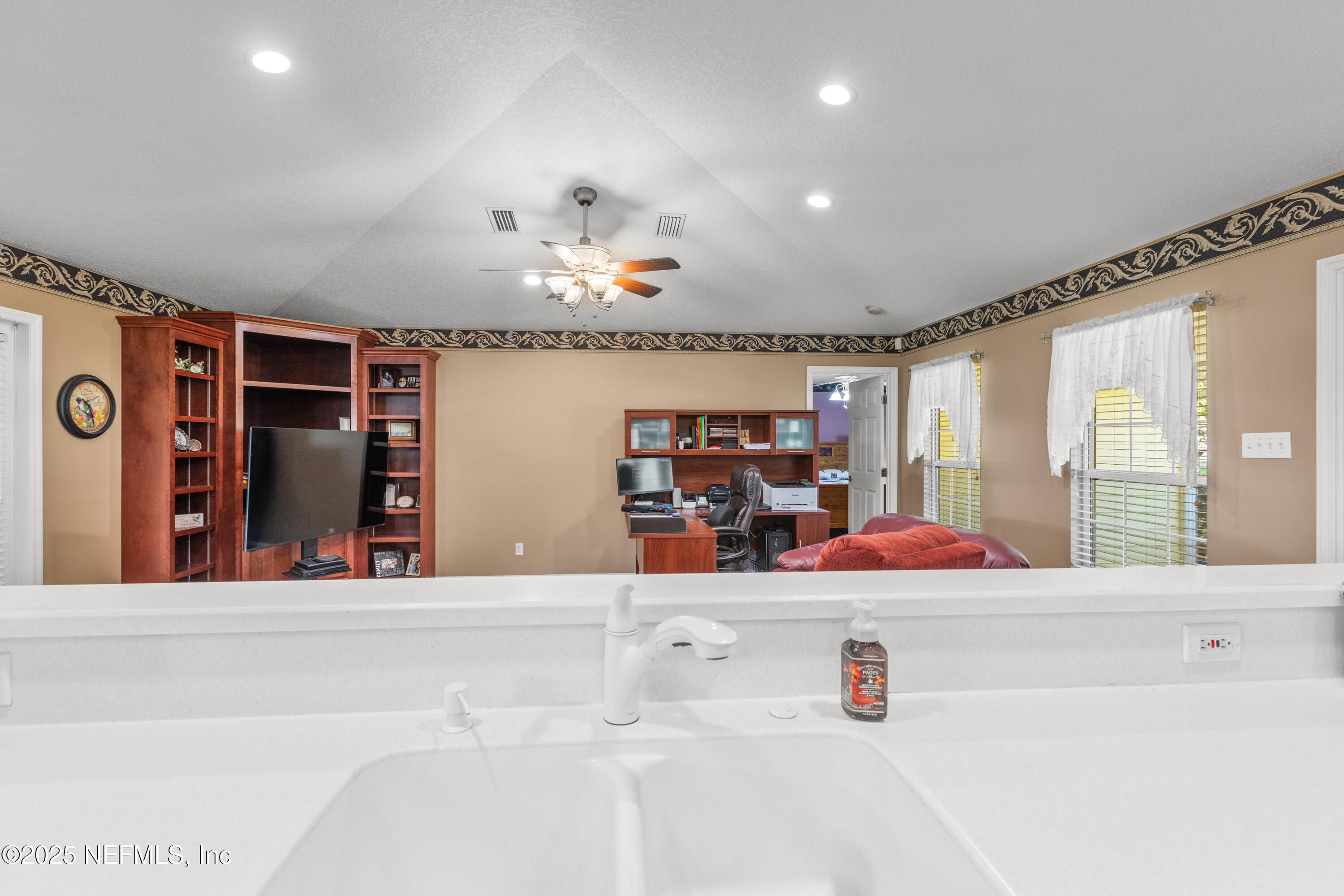 618 Southeast 44th Street Keystone Heights, FL 32656 - Photo 37 of 66 a open kitchen with stainless steel appliances kitchen island a large counter top and a flat screen tv