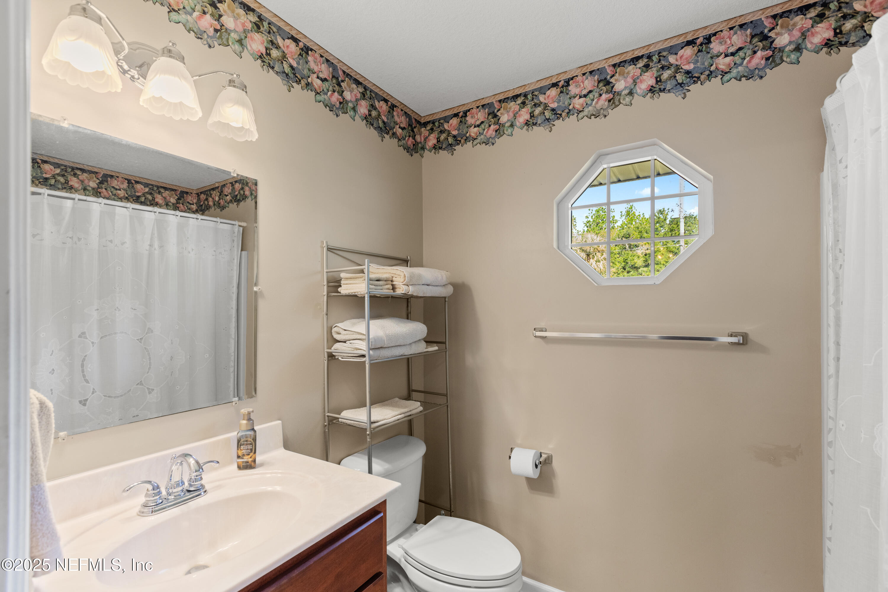 618 Southeast 44th Street Keystone Heights, FL 32656 - Photo 38 of 66 a bathroom with a sink a toilet and shower curtain