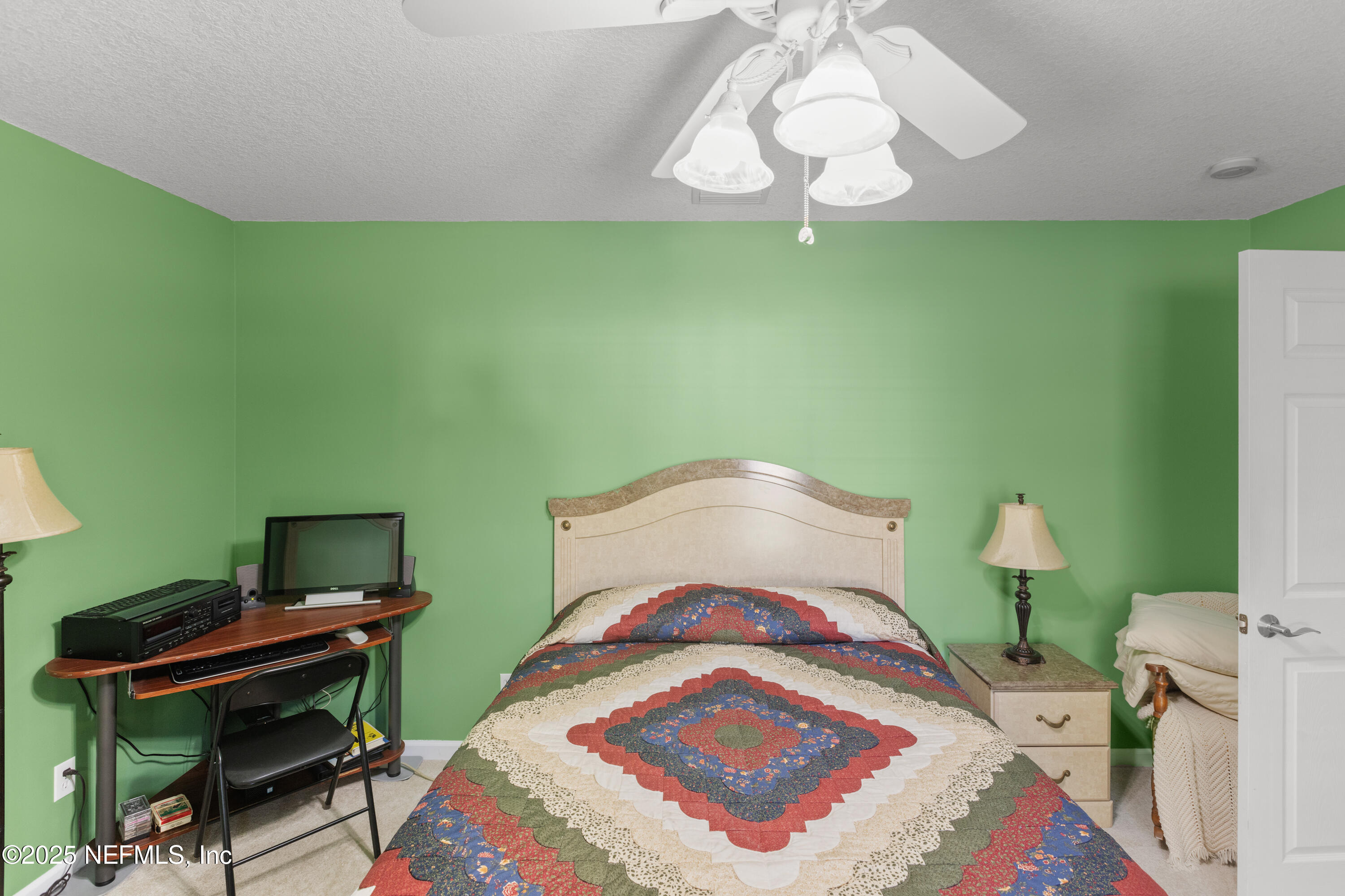 618 Southeast 44th Street Keystone Heights, FL 32656 - Photo 43 of 66 a bedroom with a bed and a chandelier