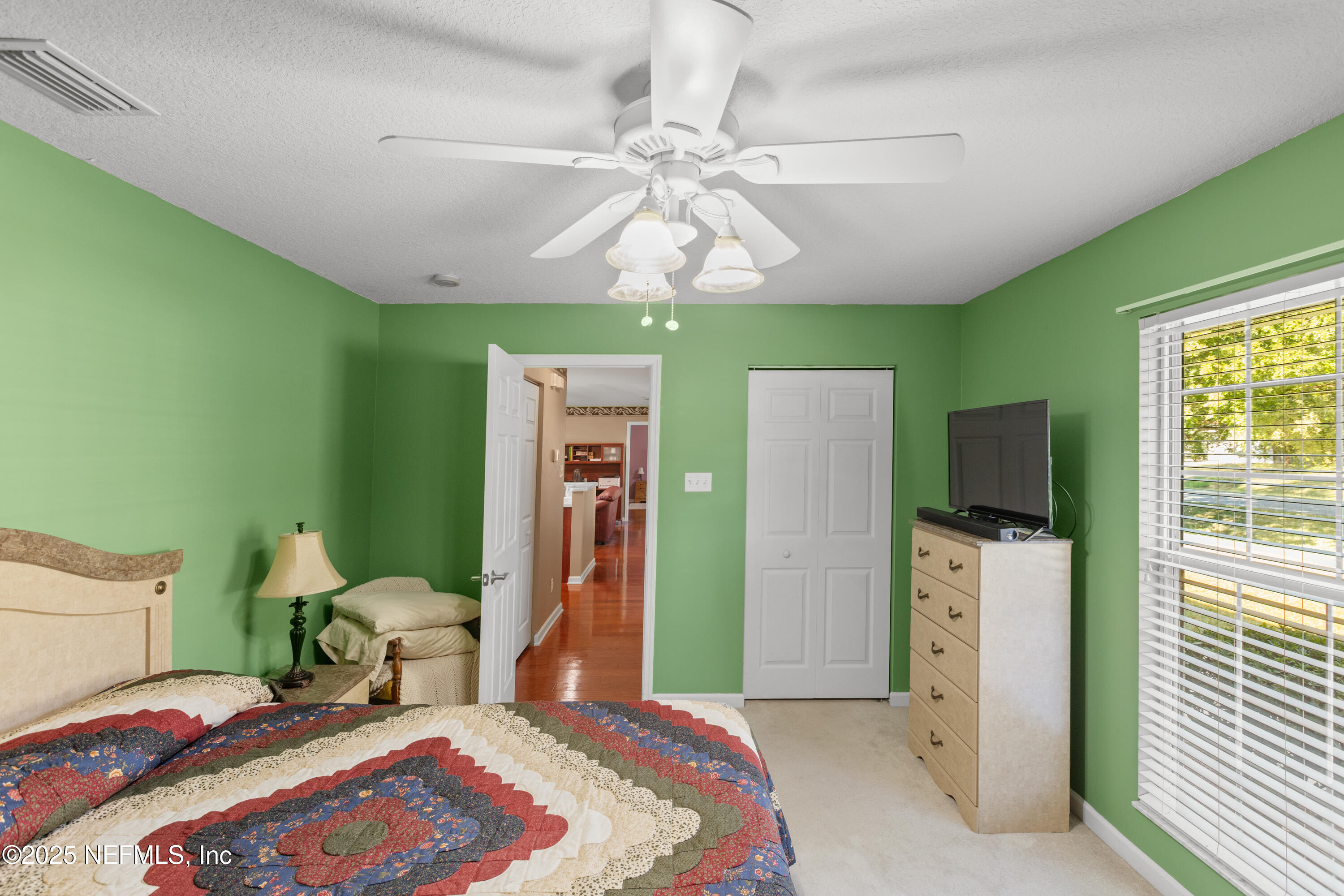 618 Southeast 44th Street Keystone Heights, FL 32656 - Photo 44 of 66 a bedroom with a bed and a chandelier