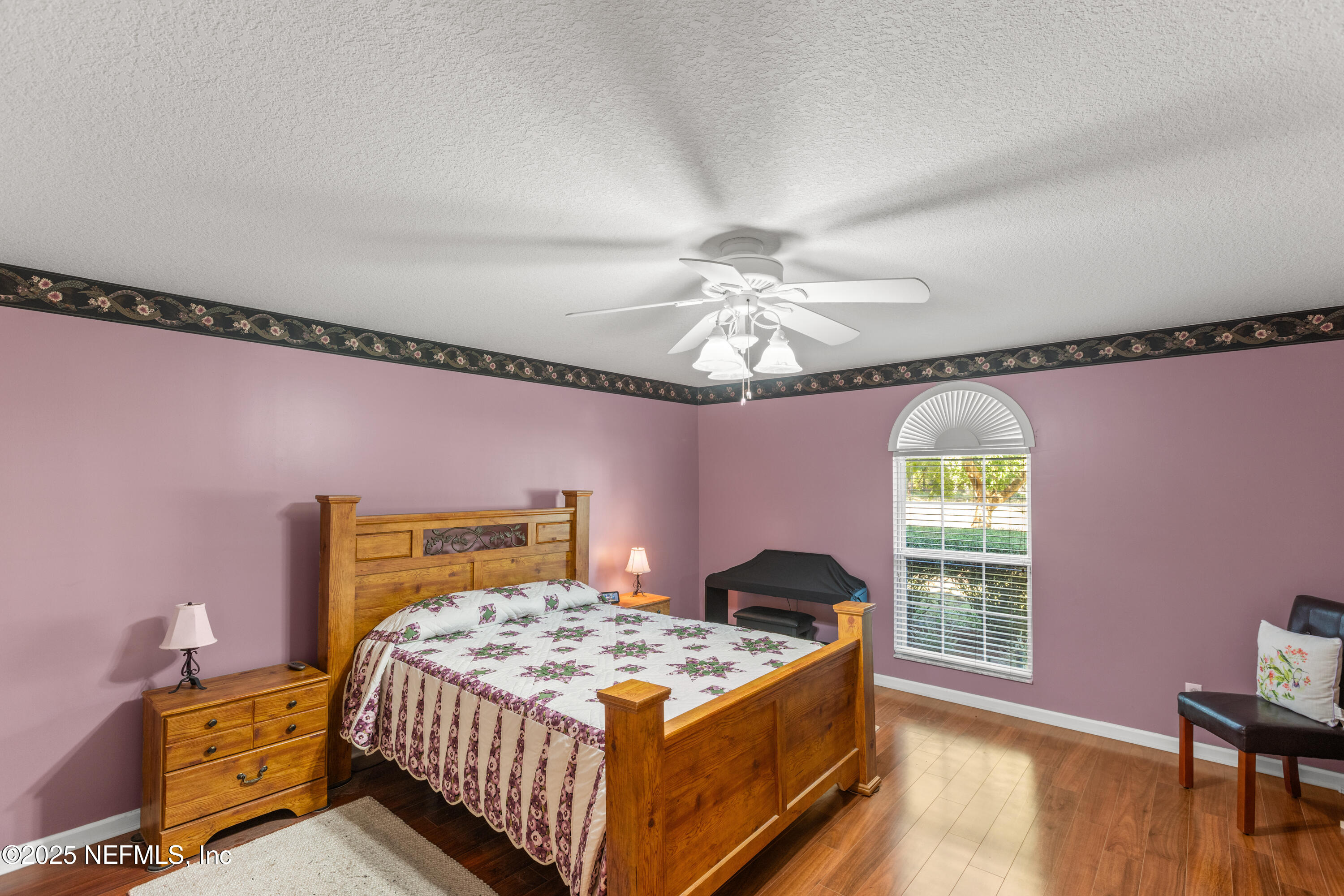 618 Southeast 44th Street Keystone Heights, FL 32656 - Photo 51 of 66 a bedroom with a bed and a chandelier
