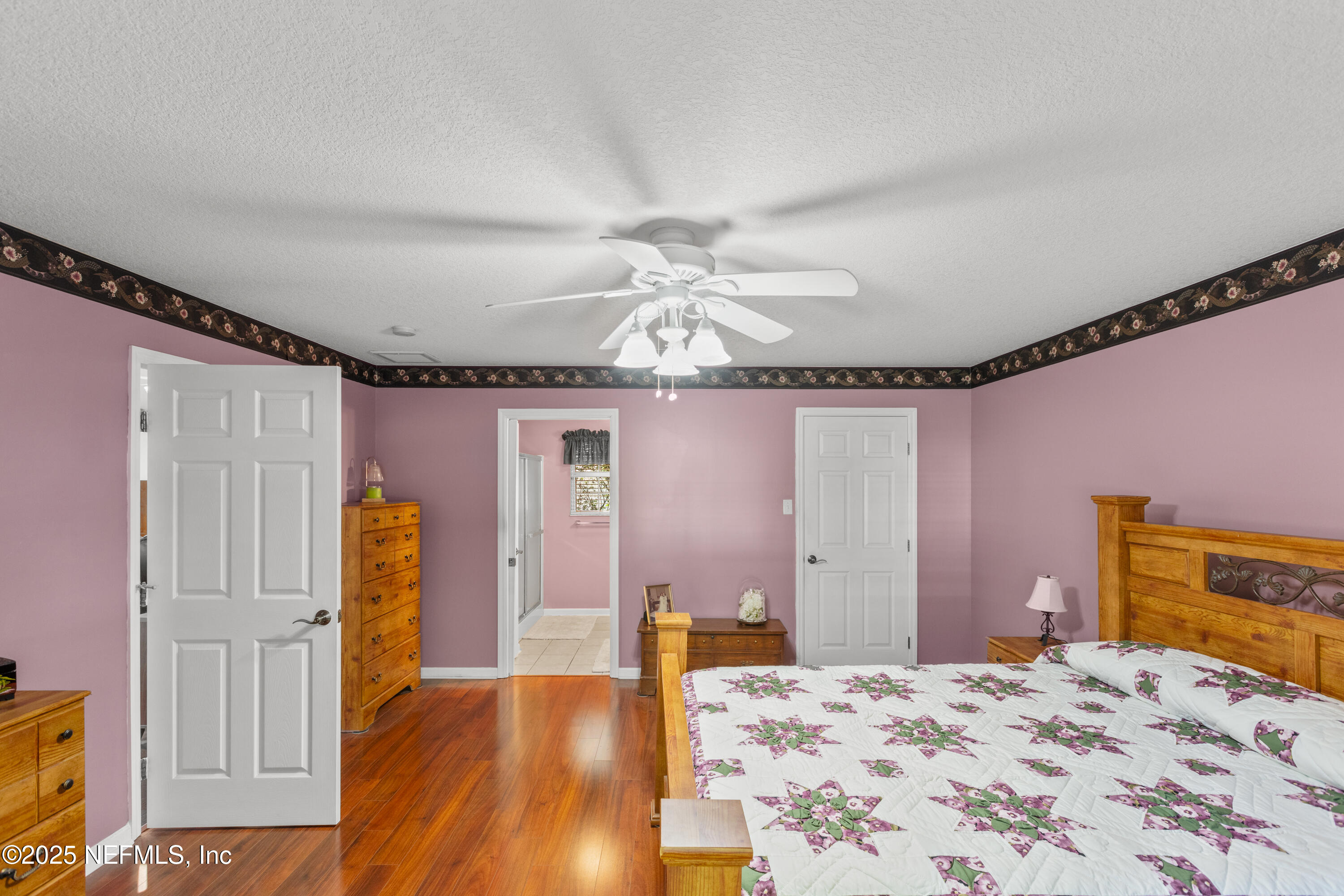 618 Southeast 44th Street Keystone Heights, FL 32656 - Photo 53 of 66 a bedroom with a bed and a chandelier
