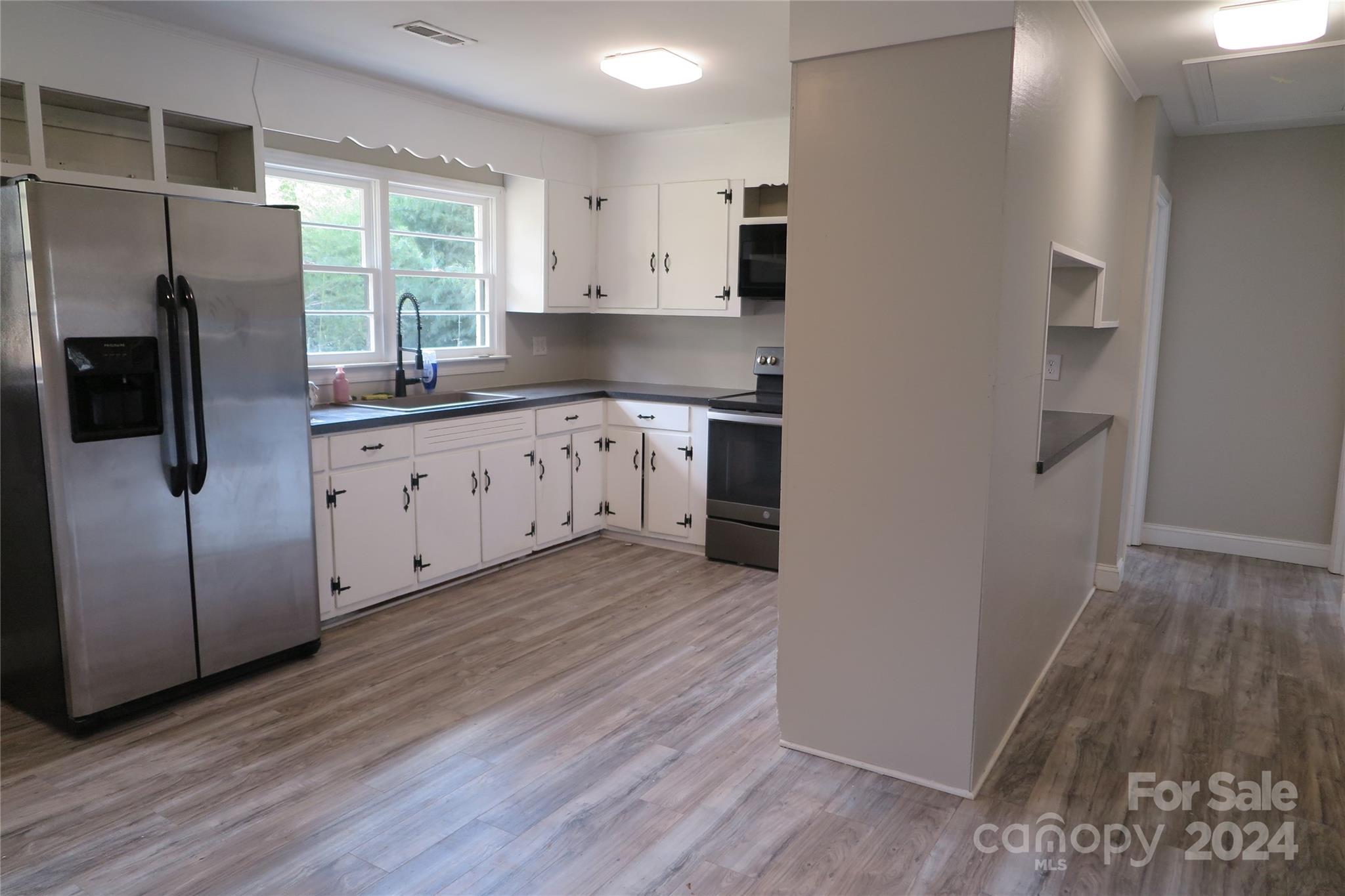 544 Loray Farm Road Dallas, NC 28034 - Photo 15 of 30 a kitchen with stainless steel appliances granite countertop a refrigerator and a sink