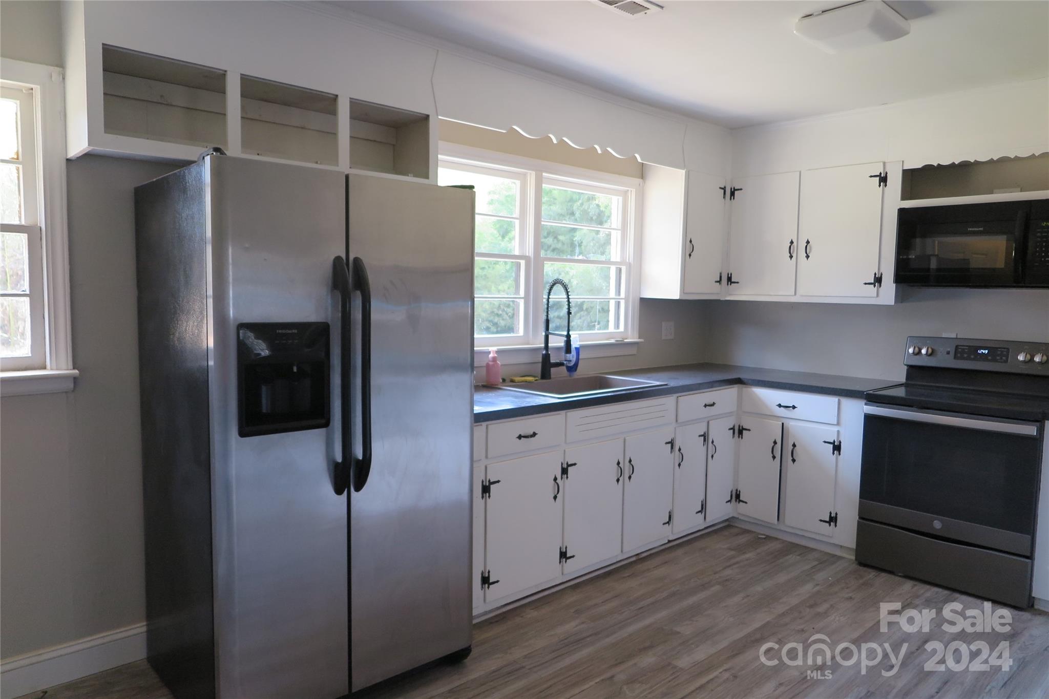 544 Loray Farm Road Dallas, NC 28034 - Photo 4 of 30 a kitchen with stainless steel appliances a refrigerator sink and microwave
