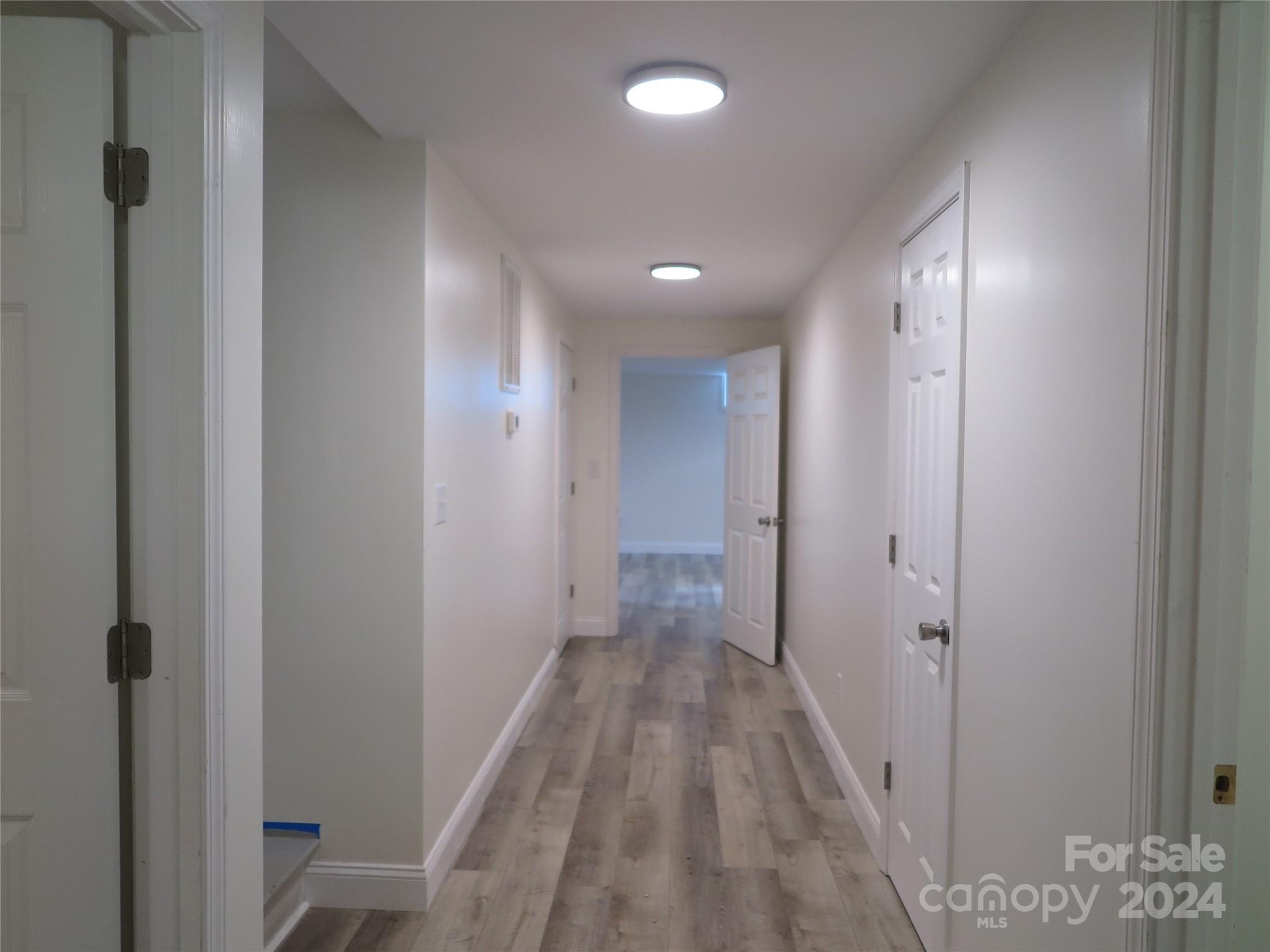 544 Loray Farm Road Dallas, NC 28034 - Photo 8 of 30 a view of a hallway with wooden floor