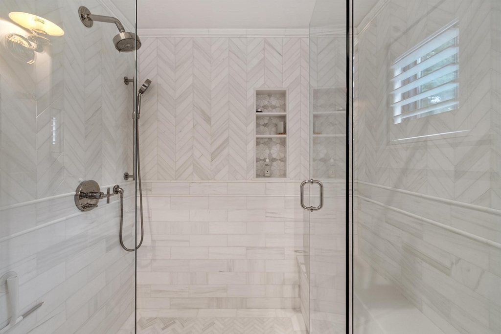 653 Main Street Concord, MA 01742 - Photo 27 of 42 a bathroom with a glass shower door