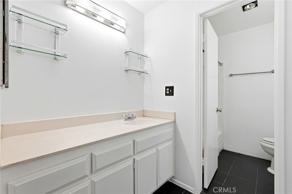 7890 East Spring Street, Unit 11E Long Beach, CA 90815 - Photo 36 of 40 a bathroom with a sink and mirror