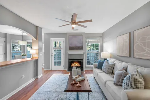a living room with furniture fireplace and window