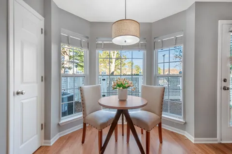 a view of a dining room with furniture window and wooden floor
